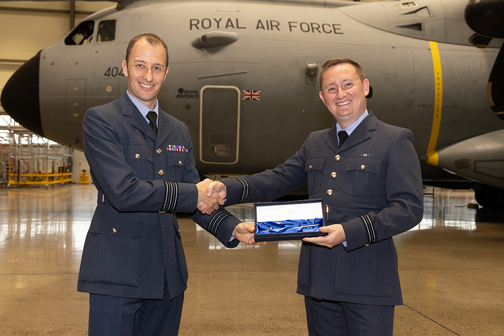 Flight Lieutenant Ewers being presented with a commemorative replica sword by Wing Commander Gorman, Service Delivery Lead in Defence Equipment & Support A400M.
